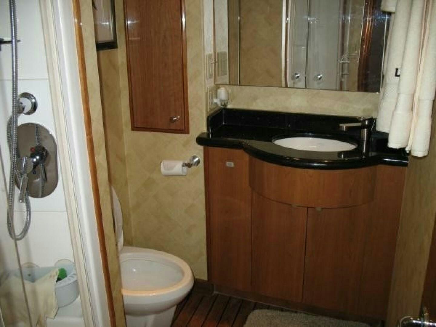 a bathroom with a sink and toilet aboard LIVNWEL Yacht for Sale