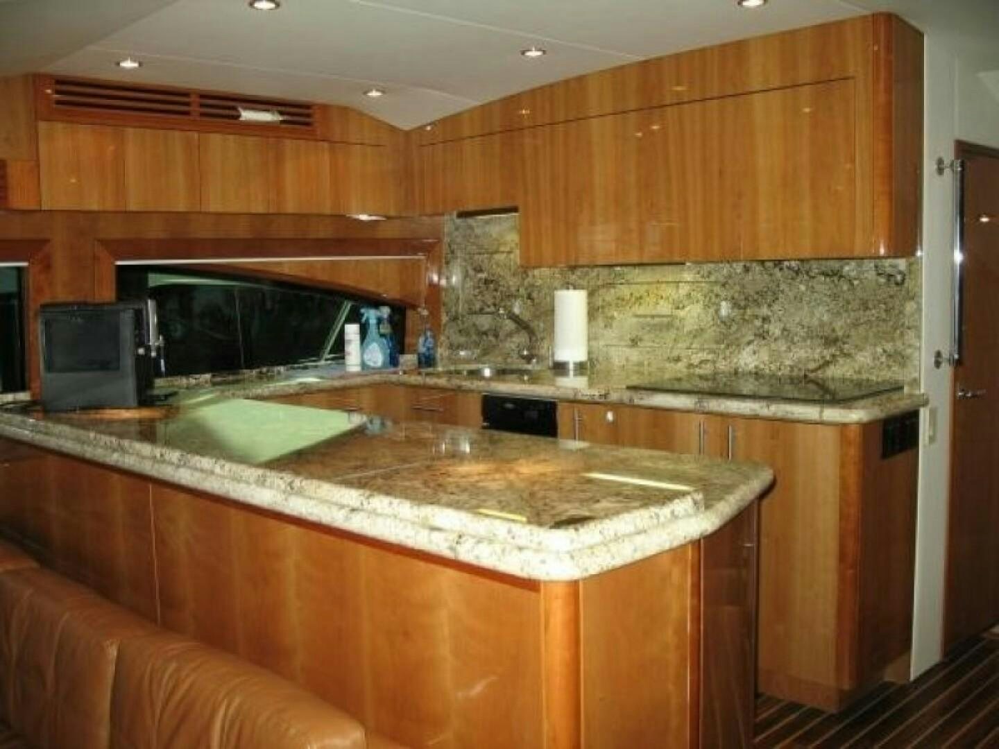 a kitchen with wooden cabinets aboard LIVNWEL Yacht for Sale