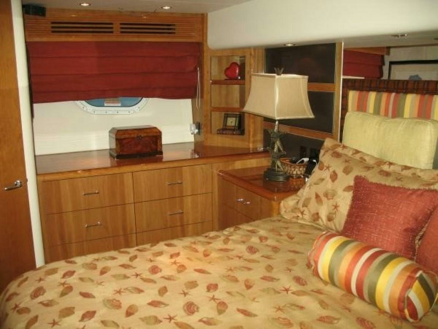 a bedroom with a bed and a desk aboard LIVNWEL Yacht for Sale