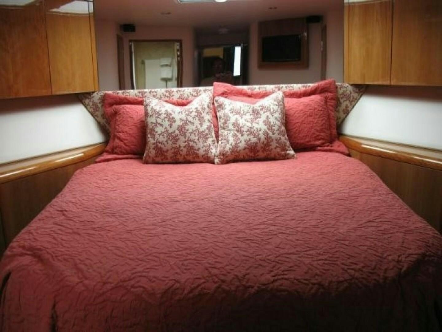 a bed with pink pillows aboard LIVNWEL Yacht for Sale