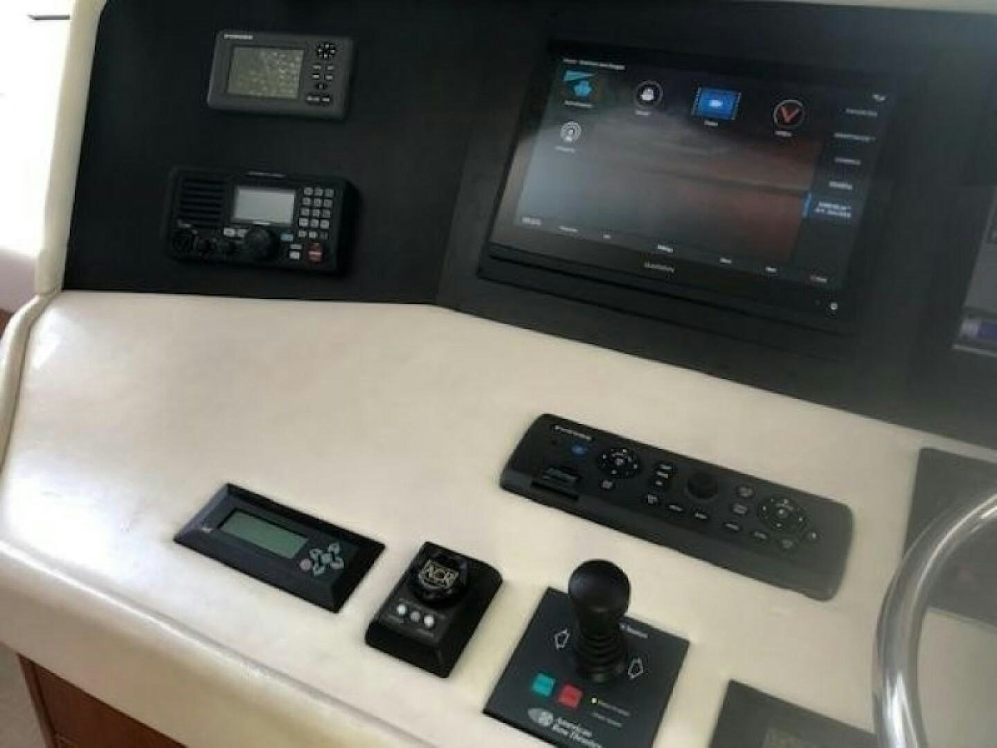 a group of remote controls on a table aboard LIVNWEL Yacht for Sale