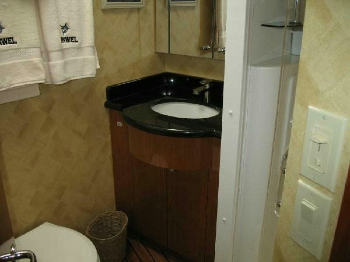 a bathroom with a sink and a mirror aboard LIVNWEL Yacht for Sale