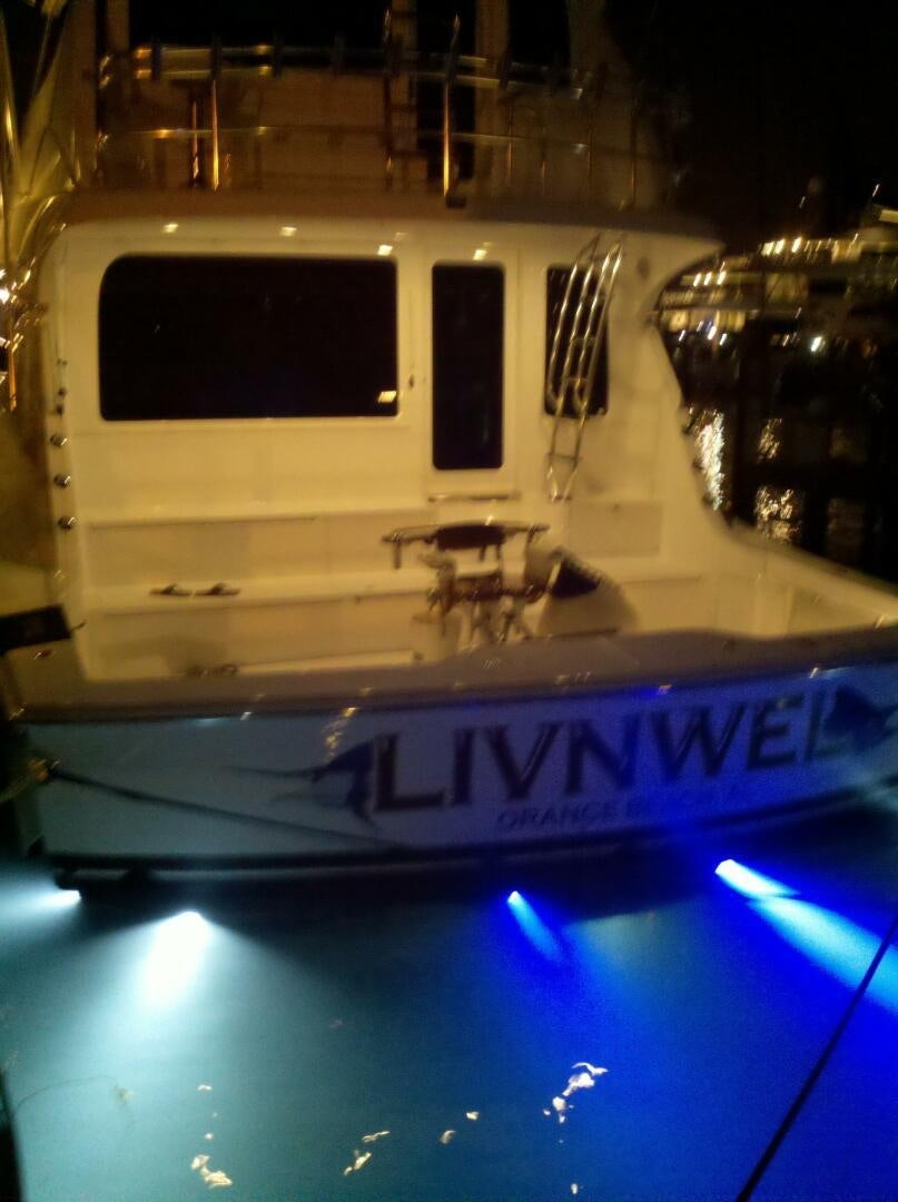 a white vehicle with a blue sign aboard LIVNWEL Yacht for Sale
