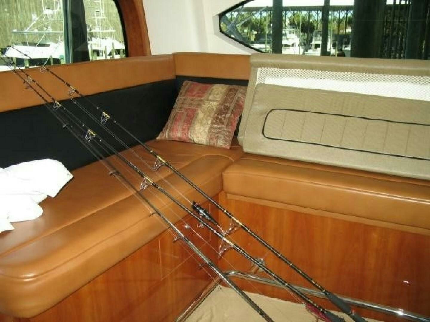 a wooden bench with a guitar leaning against it aboard LIVNWEL Yacht for Sale