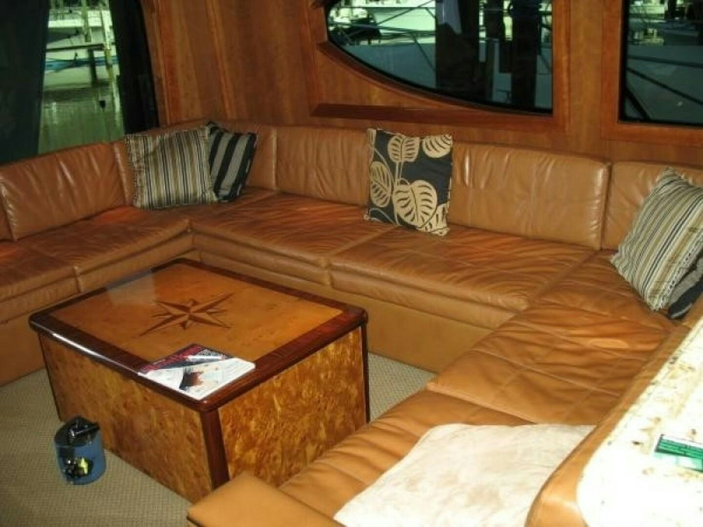 a living room with a brown couch aboard LIVNWEL Yacht for Sale