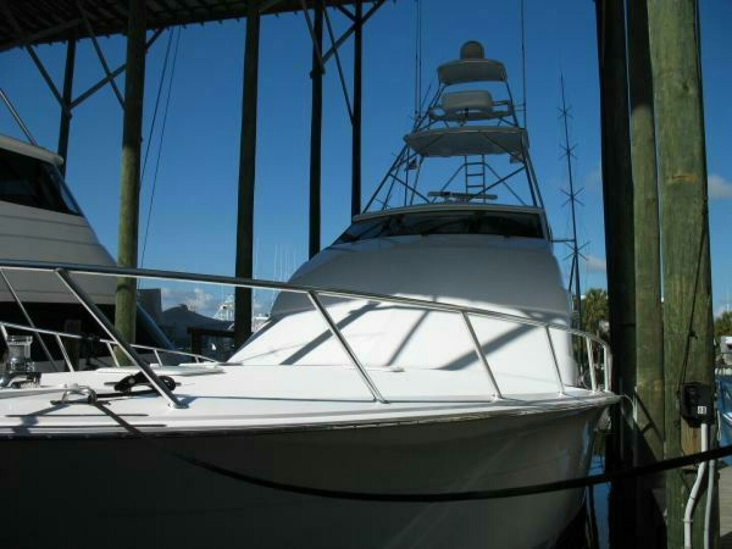 a white yacht in a harbor aboard LIVNWEL Yacht for Sale