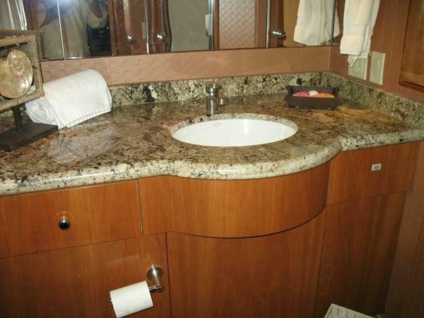 a bathroom with a sink and a mirror aboard LIVNWEL Yacht for Sale
