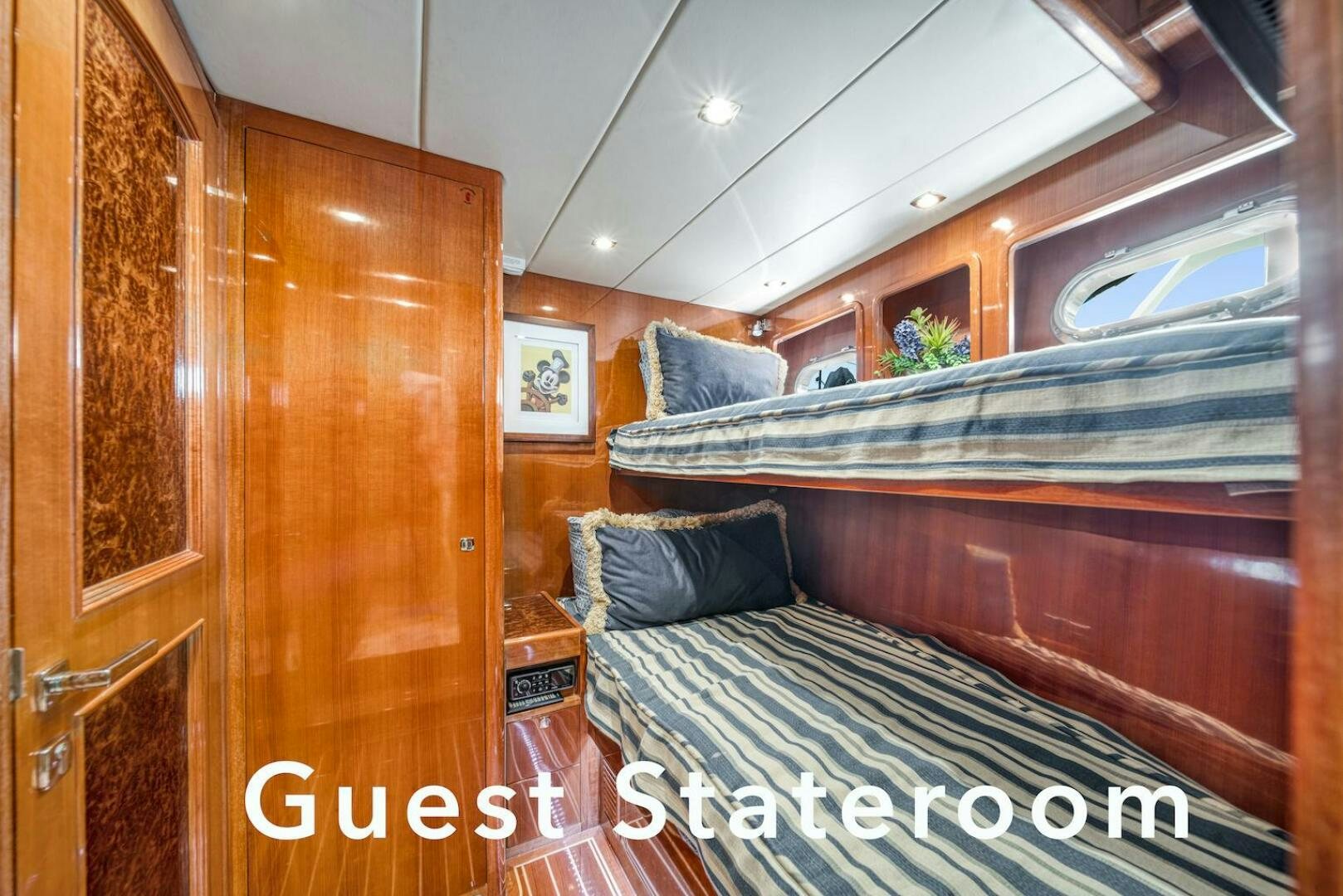 a room with a bed and a wood cabinet aboard ESCAPE Yacht for Sale