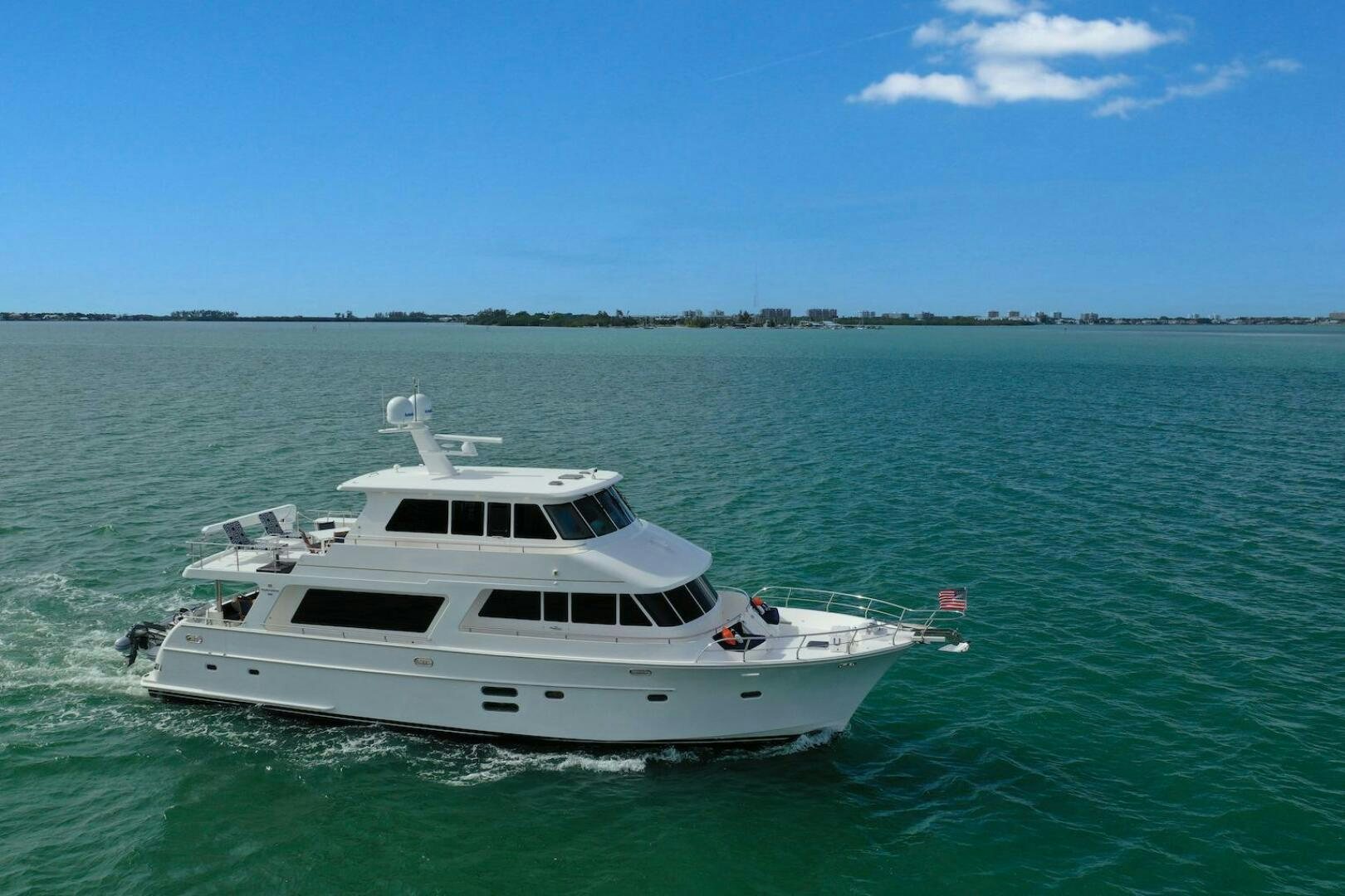 a white boat in the water aboard ESCAPE Yacht for Sale