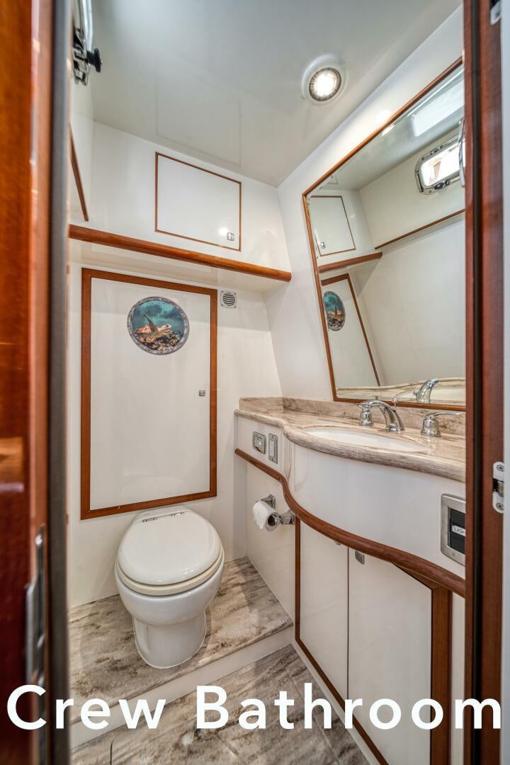 a bathroom with a toilet and sink aboard ESCAPE Yacht for Sale