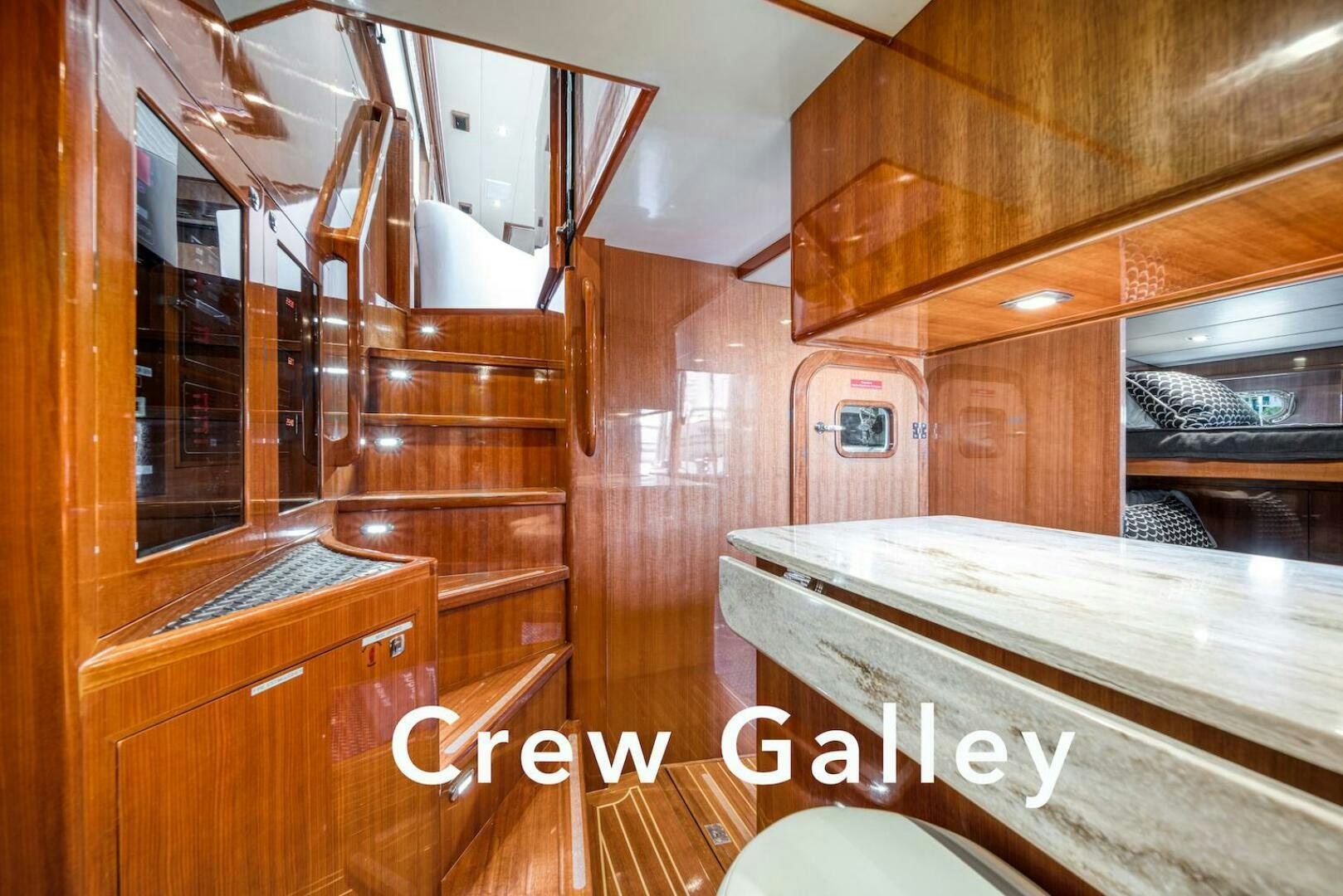 a wooden cabin with wooden furniture aboard ESCAPE Yacht for Sale