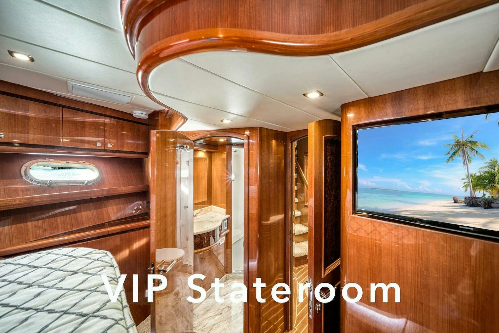 a room with a bed and a television aboard ESCAPE Yacht for Sale