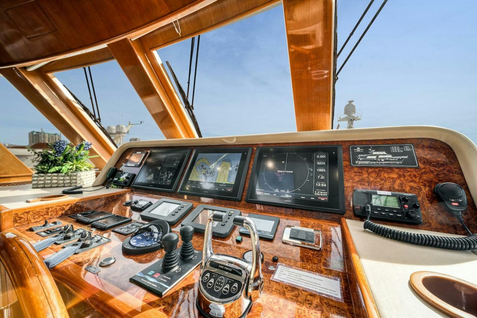 a wooden table with electronic devices aboard ESCAPE Yacht for Sale