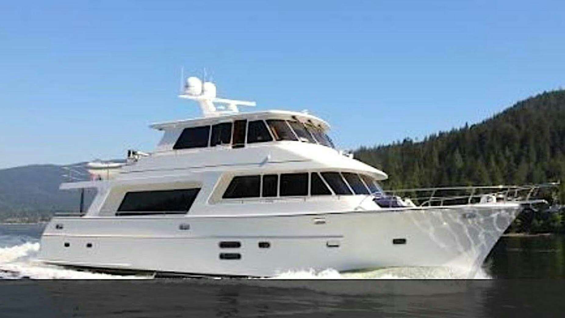 a white yacht on the water aboard ESCAPE Yacht for Sale