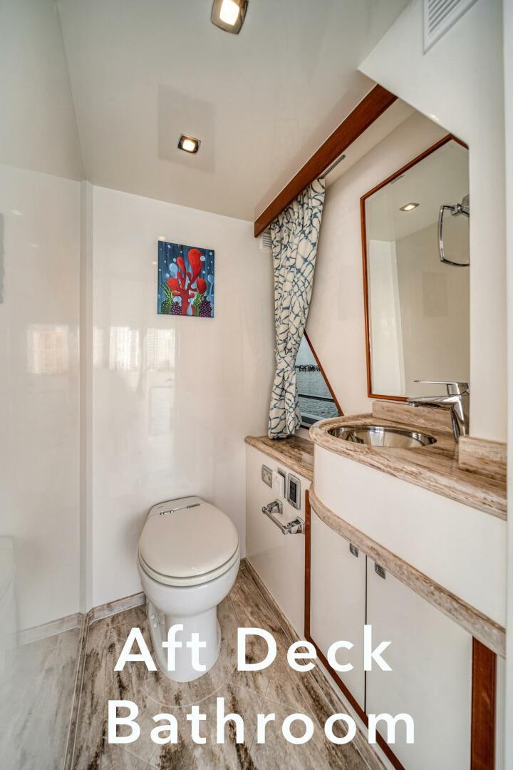 a bathroom with a toilet and sink aboard ESCAPE Yacht for Sale