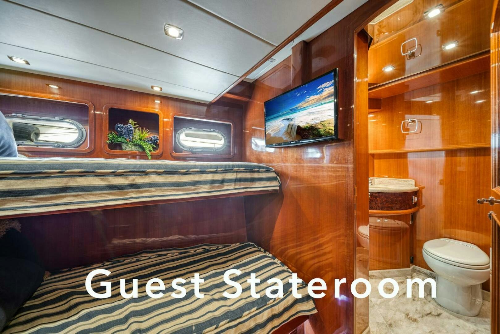 a bathroom with a television on the wall aboard ESCAPE Yacht for Sale