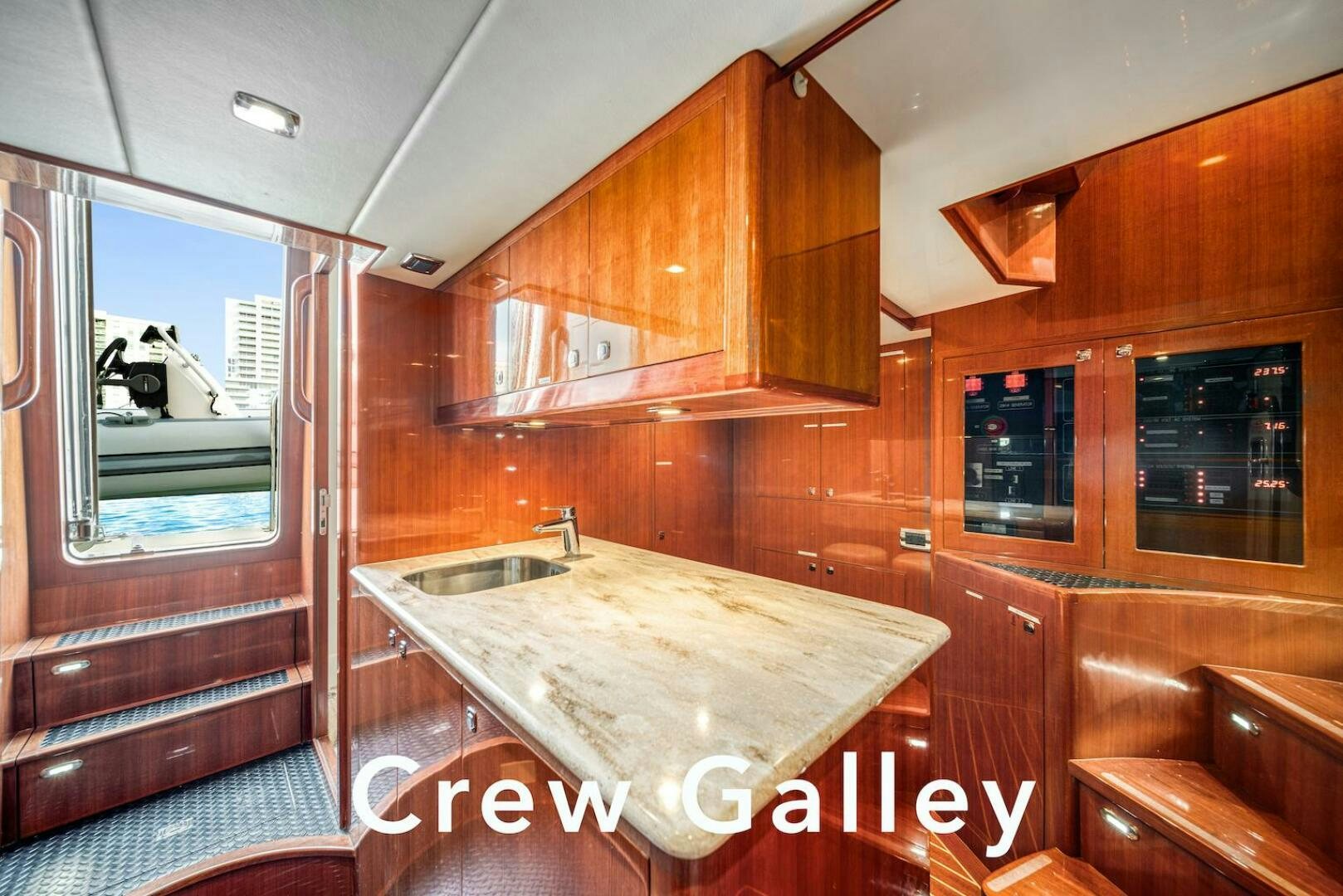 a kitchen with wooden cabinets aboard ESCAPE Yacht for Sale