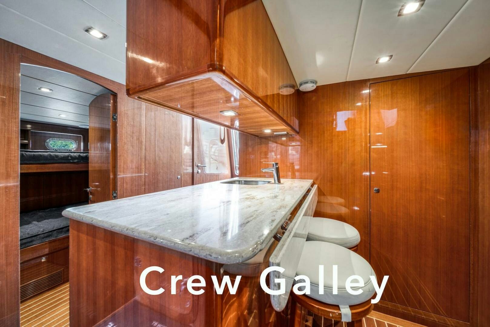 a kitchen with wooden cabinets aboard ESCAPE Yacht for Sale