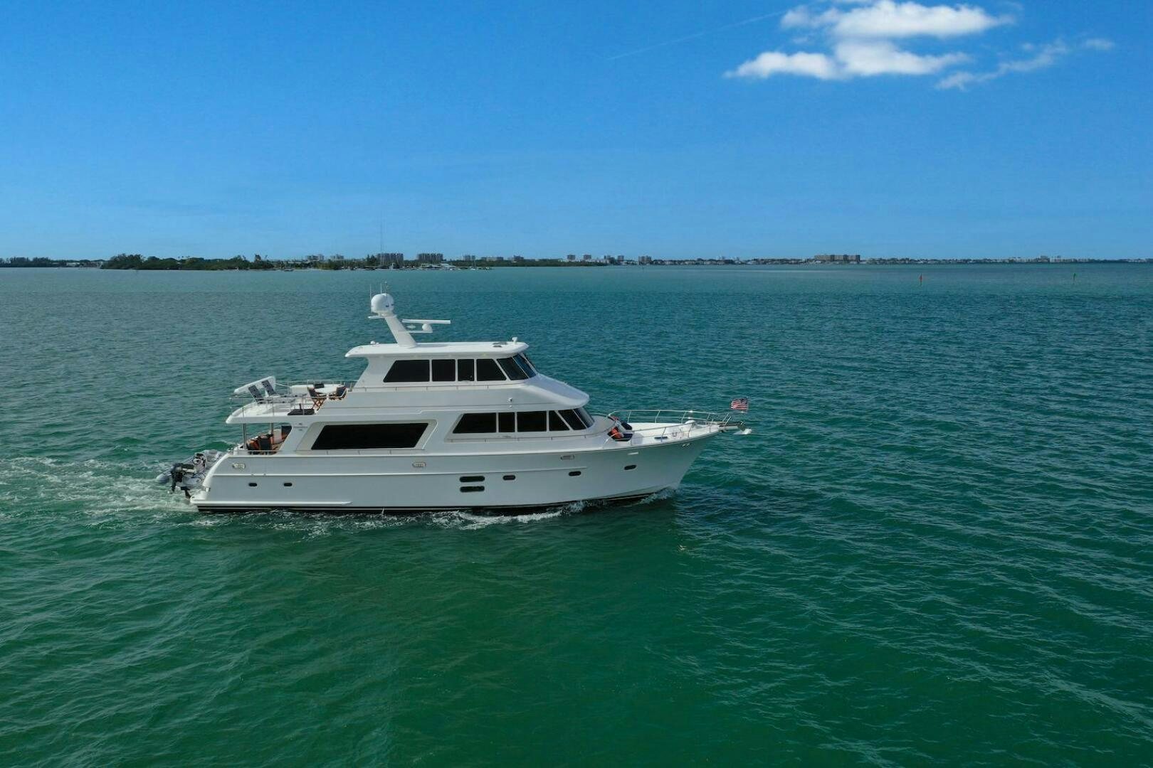 a white boat in the water aboard ESCAPE Yacht for Sale