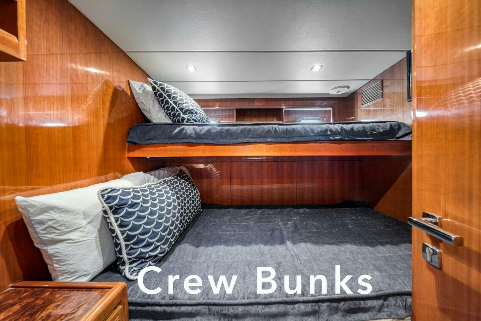 a bed with a wooden headboard aboard ESCAPE Yacht for Sale