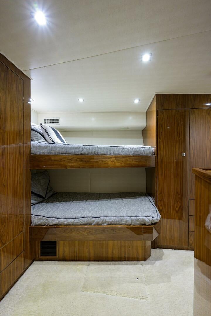 a room with bunk beds aboard 80' VIKING Yacht for Sale