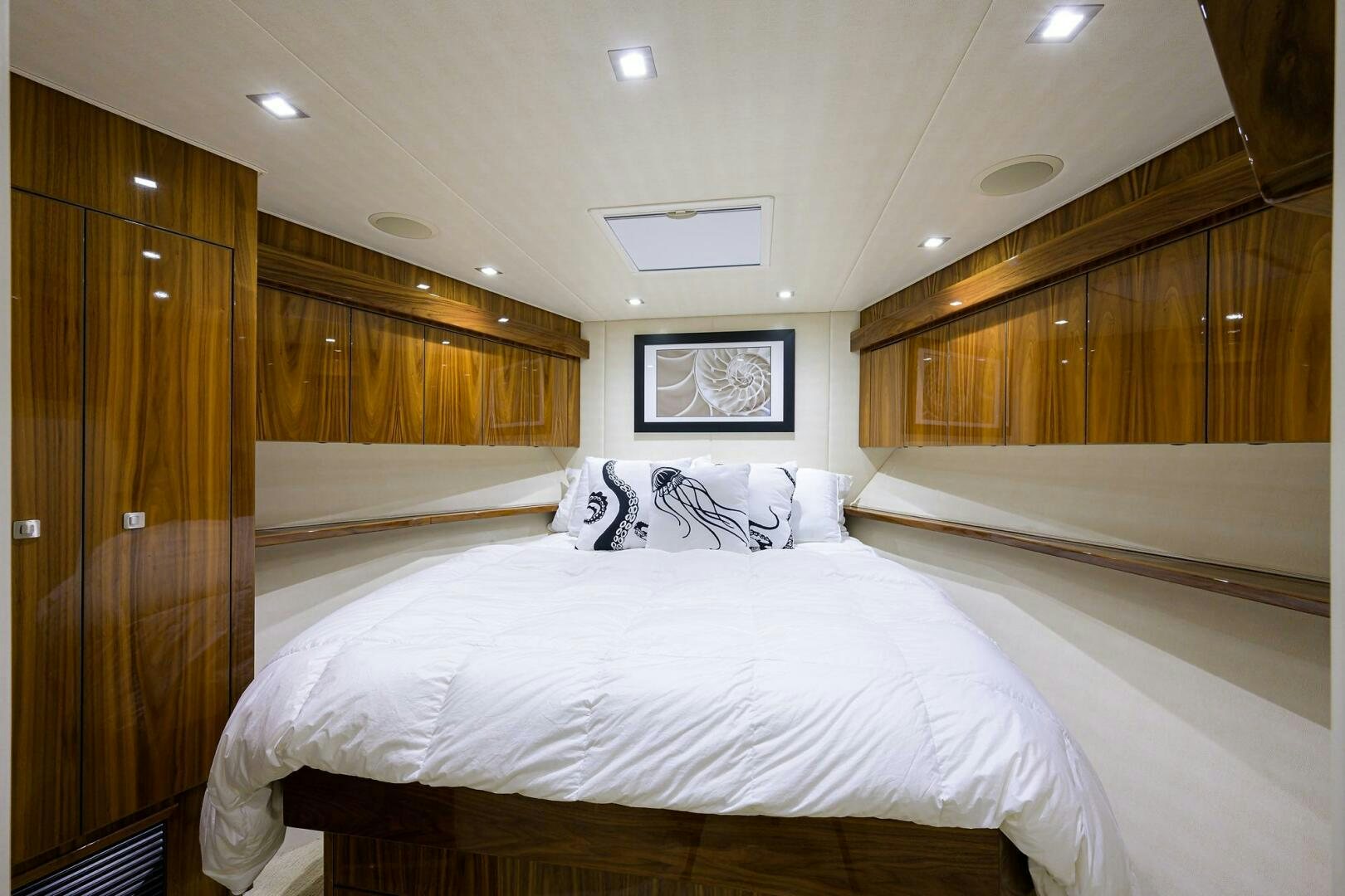a room with a bed and a television aboard 80' VIKING Yacht for Sale