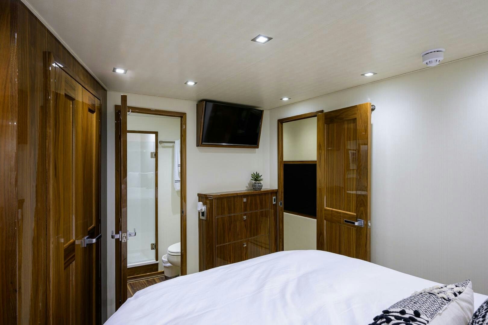 a bedroom with a bed and a television aboard 80' VIKING Yacht for Sale
