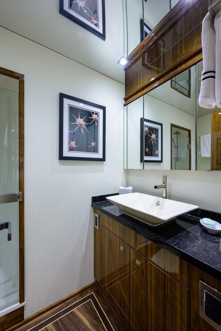 a bathroom with a sink and a mirror aboard 80' VIKING Yacht for Sale