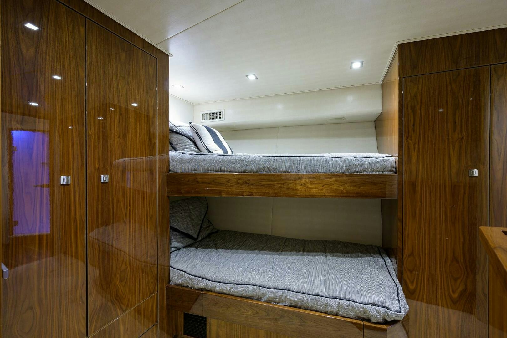 a room with a bed and a closet aboard 80' VIKING Yacht for Sale