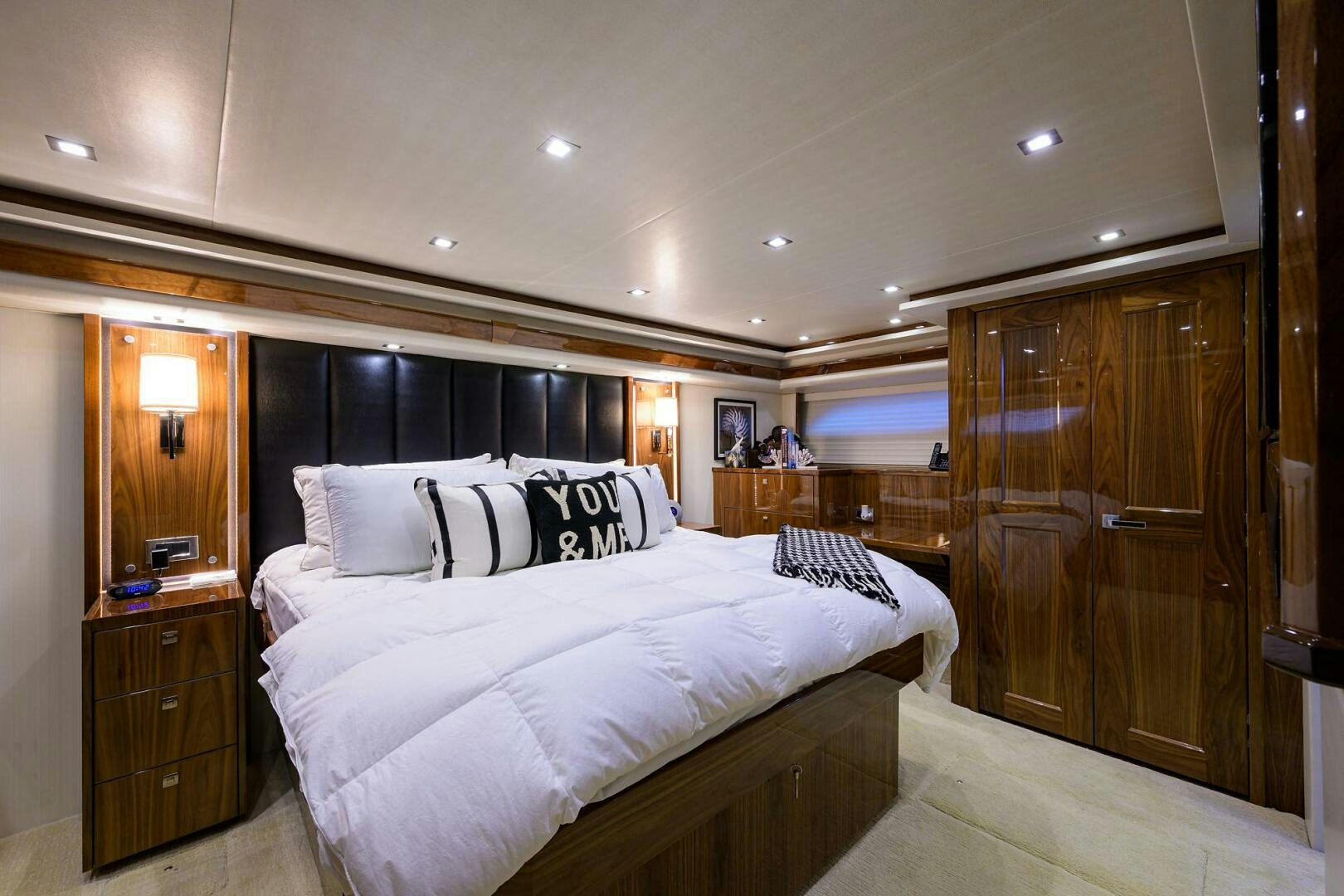 a bedroom with a bed and a closet aboard 80' VIKING Yacht for Sale
