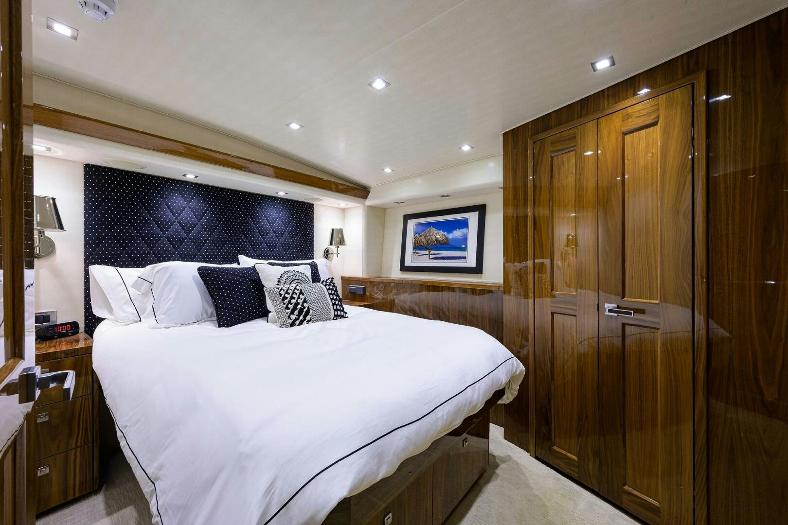 a bedroom with a bed and a closet aboard 80' VIKING Yacht for Sale