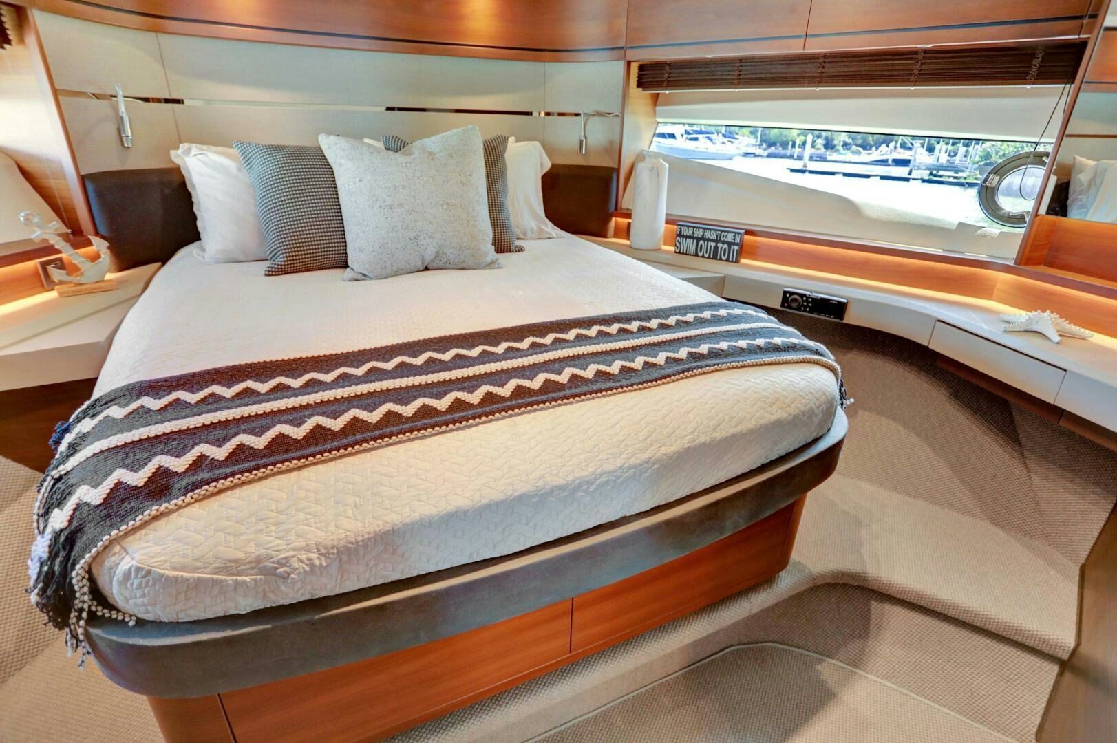 a bed with a striped blanket aboard REAL SLICK Yacht for Sale