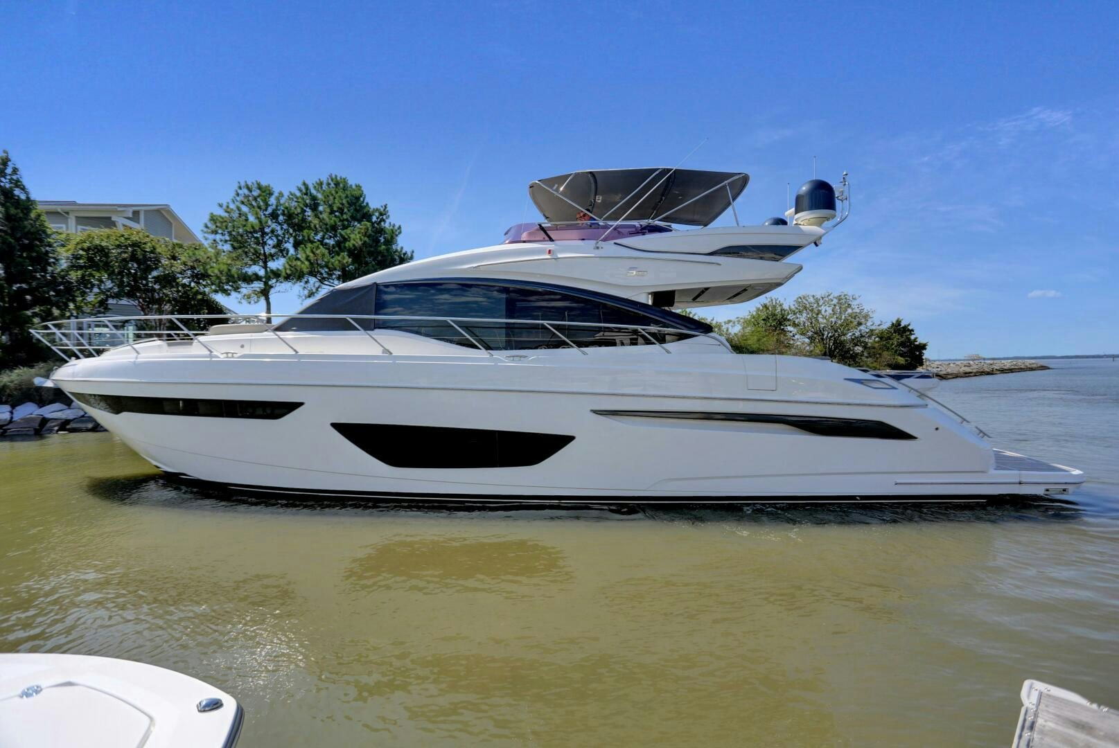 a white boat on a body of water aboard REAL SLICK Yacht for Sale