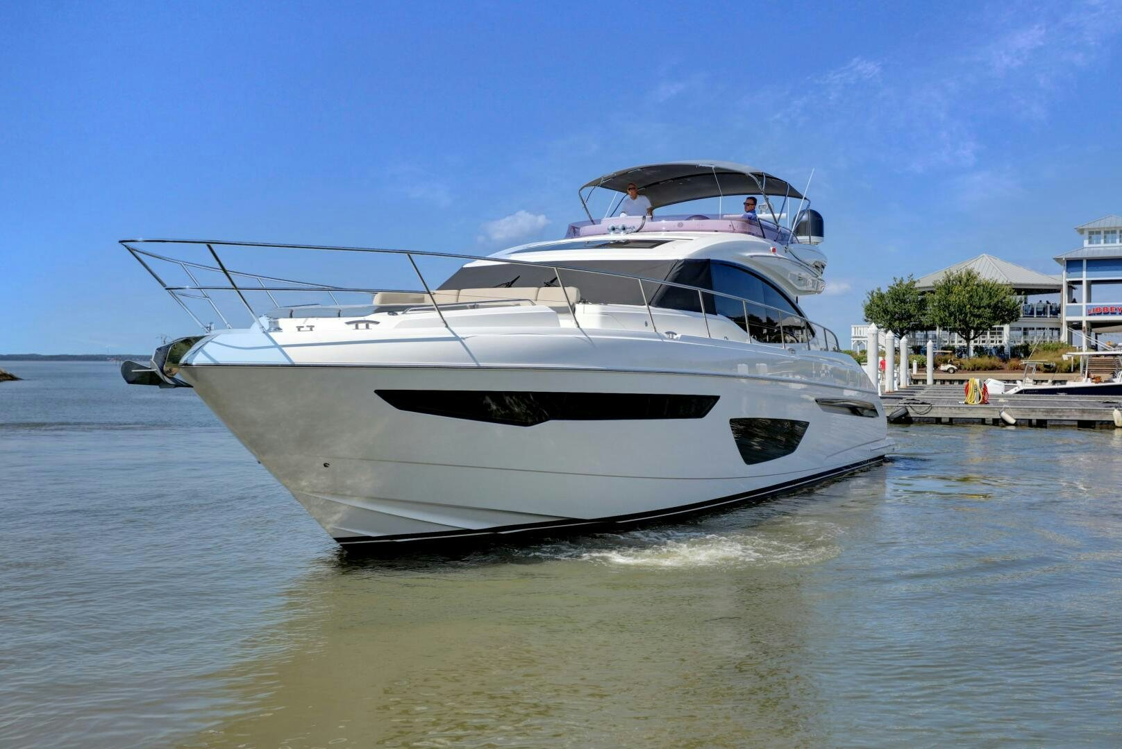 a white boat on a river aboard REAL SLICK Yacht for Sale