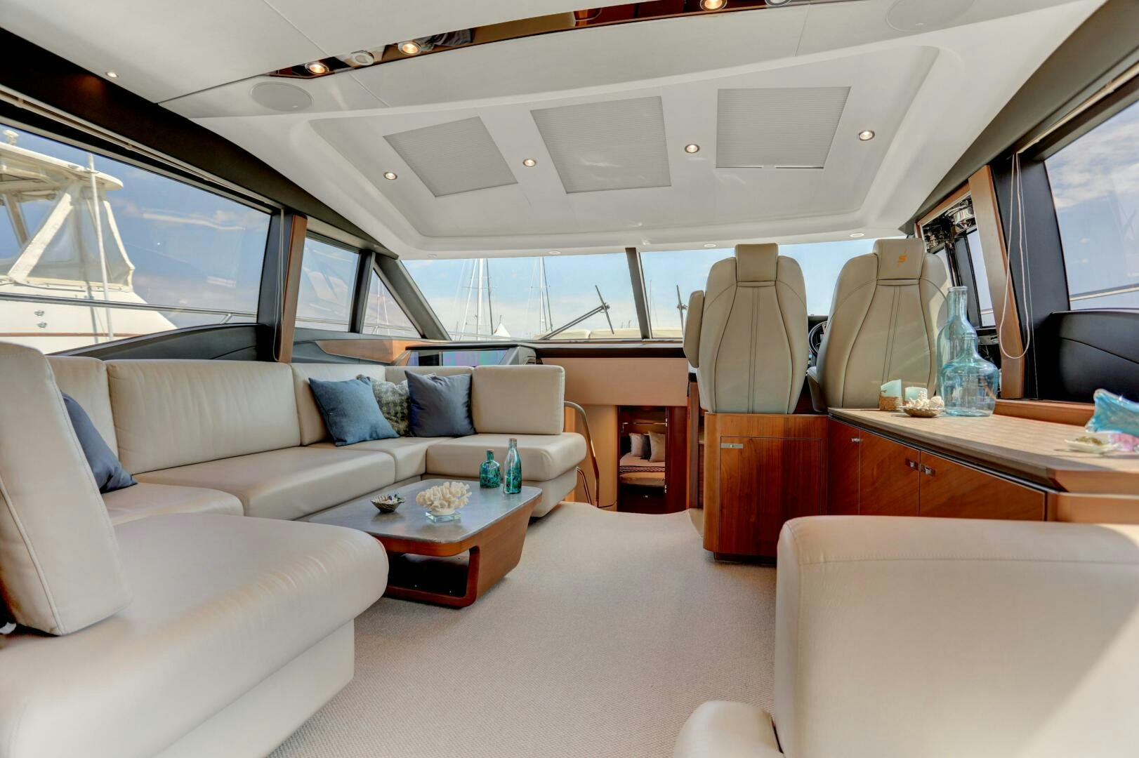 a white car with a couch and a table in it aboard REAL SLICK Yacht for Sale
