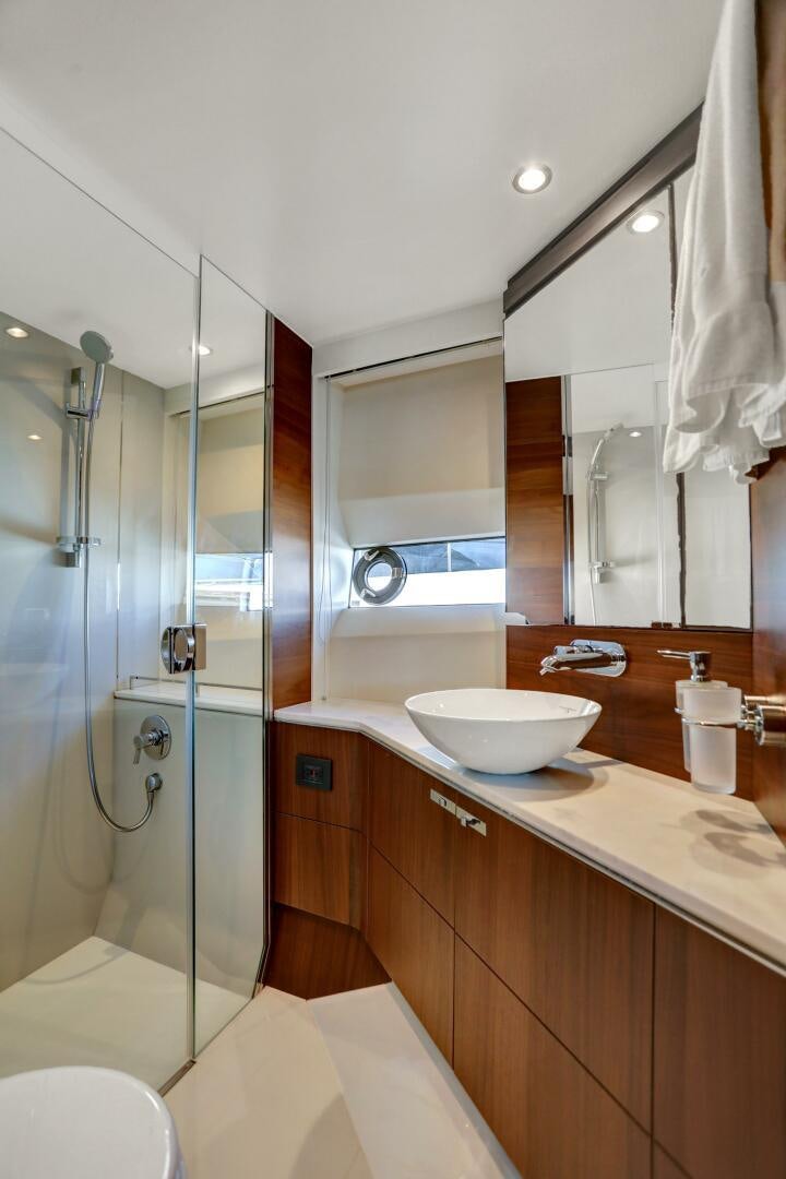 a bathroom with a glass shower aboard REAL SLICK Yacht for Sale