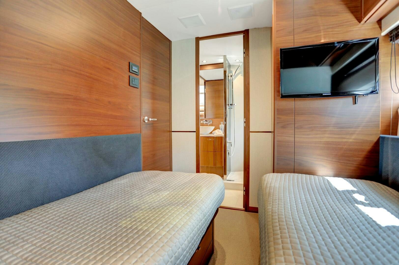 a room with a bed and a microwave aboard REAL SLICK Yacht for Sale