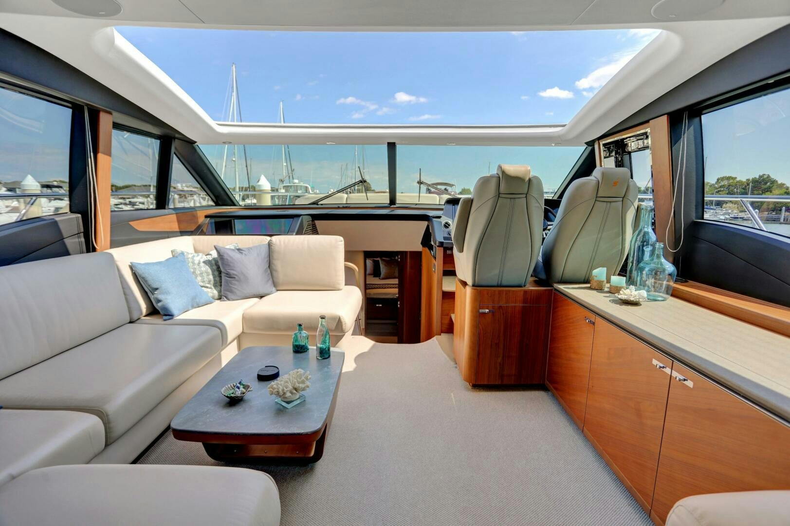 a room with a couch and a table with bottles on it aboard REAL SLICK Yacht for Sale