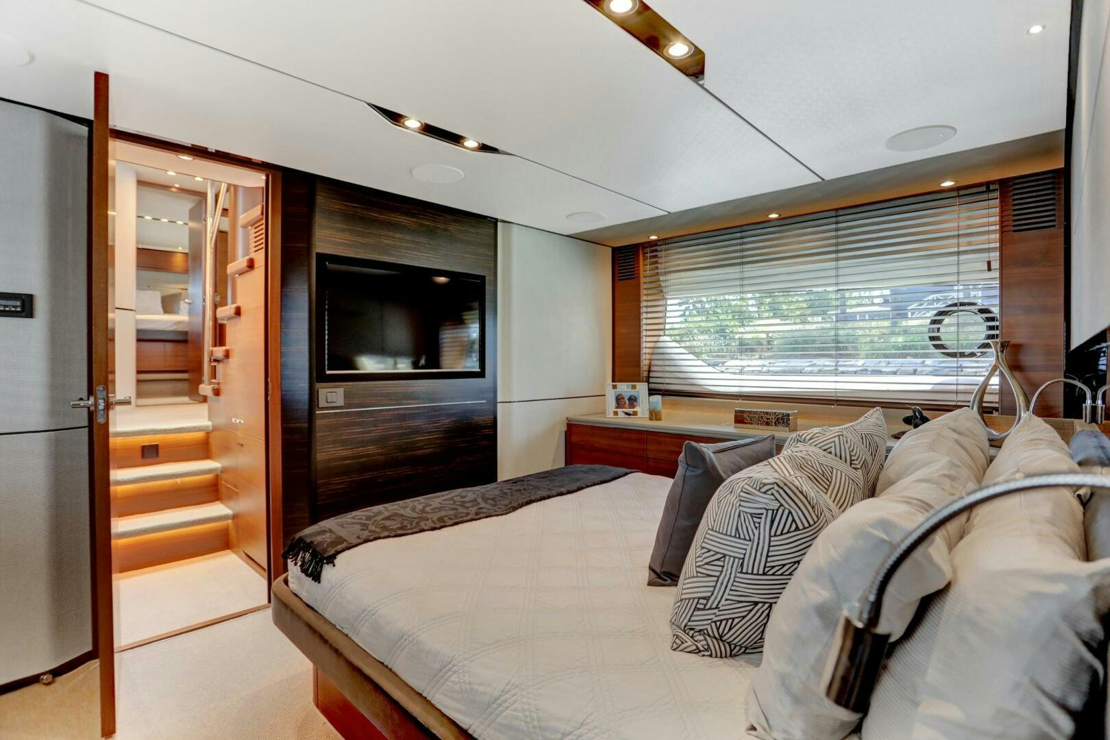 a bedroom with a bed and a tv aboard REAL SLICK Yacht for Sale