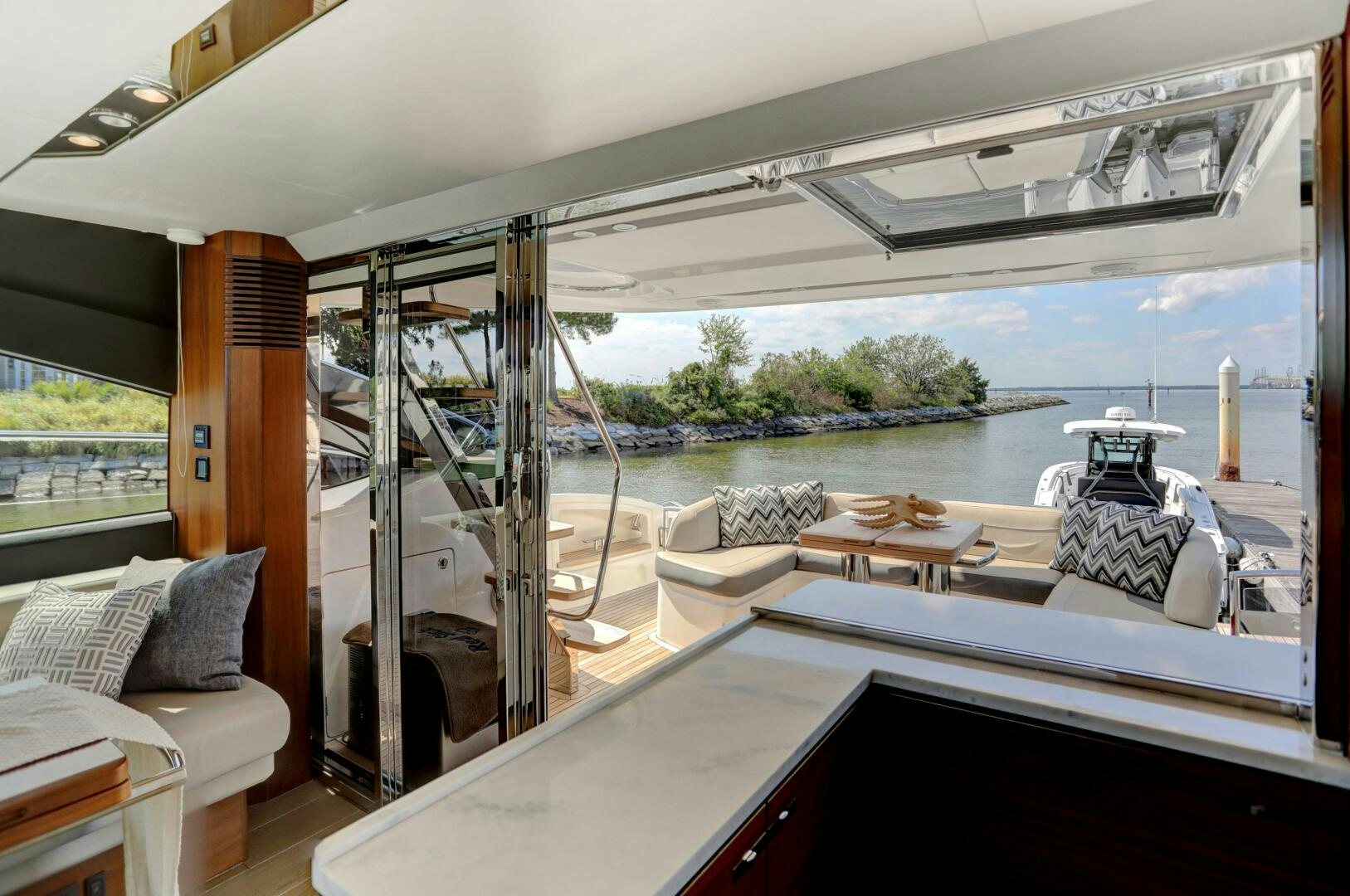 a room with a view of the water and the backyard aboard REAL SLICK Yacht for Sale