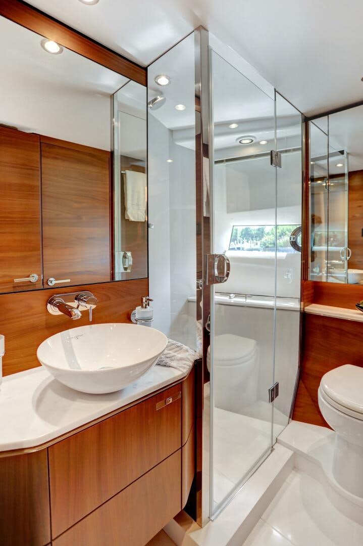 a bathroom with a glass shower door aboard REAL SLICK Yacht for Sale