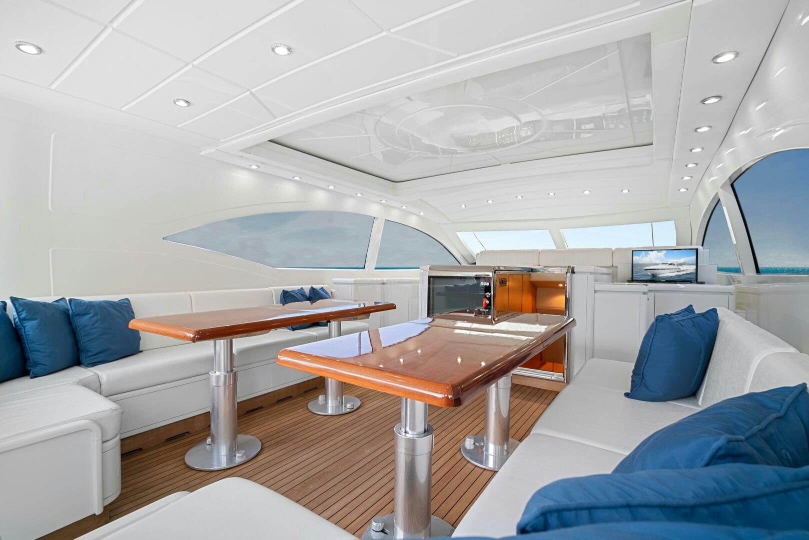 a room with a table and couch aboard NONE Yacht for Sale