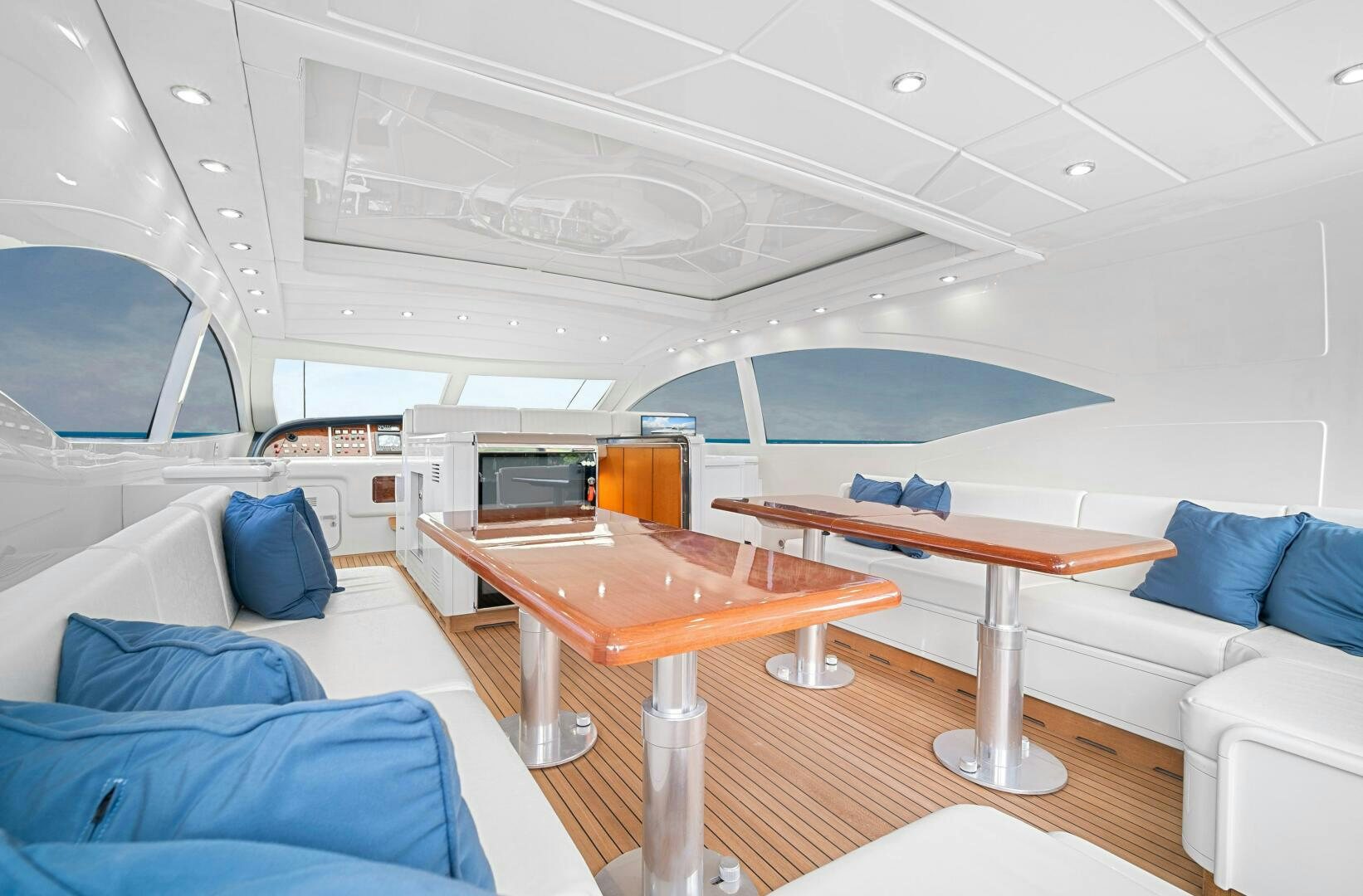 a room with a table and couches aboard NONE Yacht for Sale