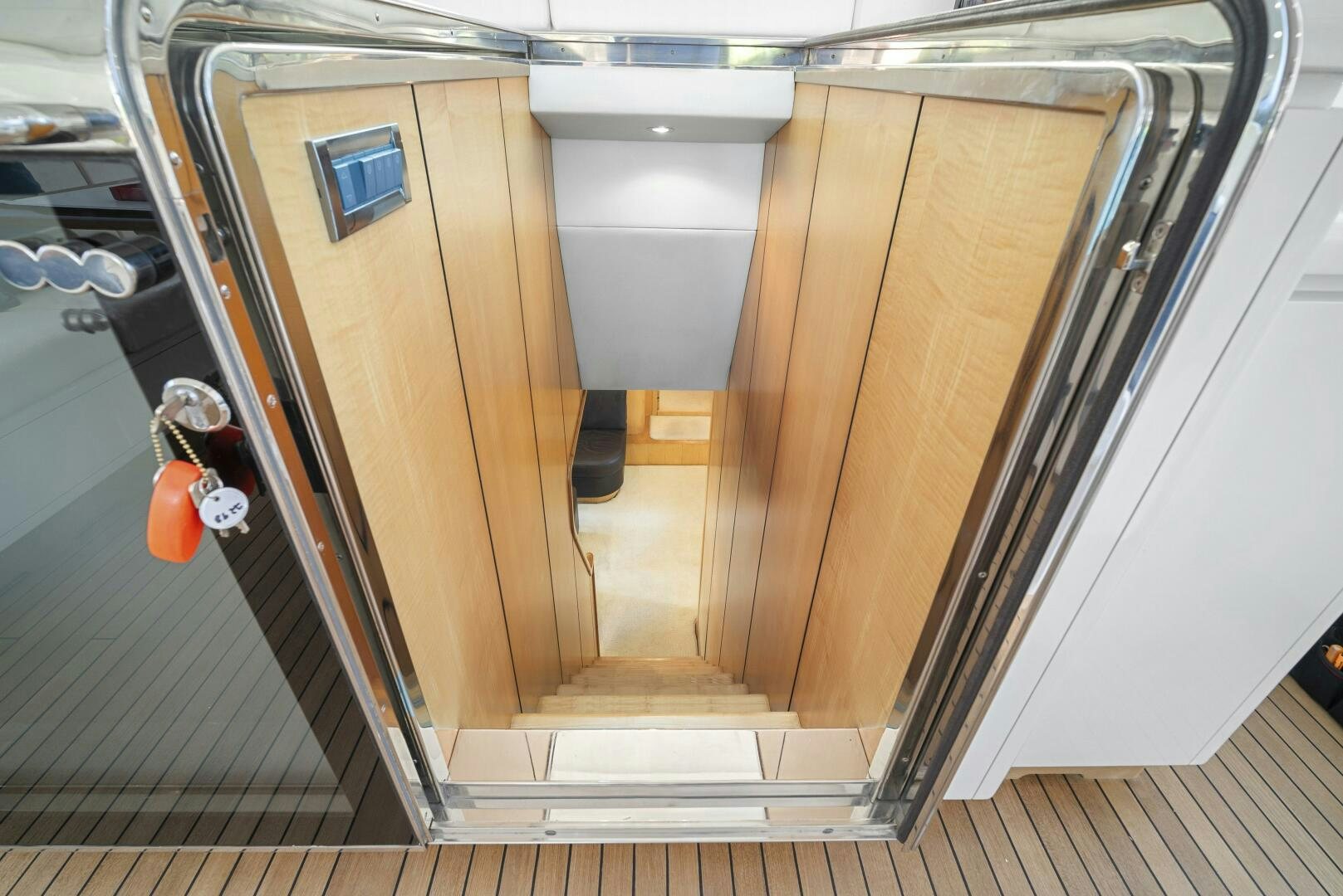 a room with a door and a shelf with objects on it aboard NONE Yacht for Sale