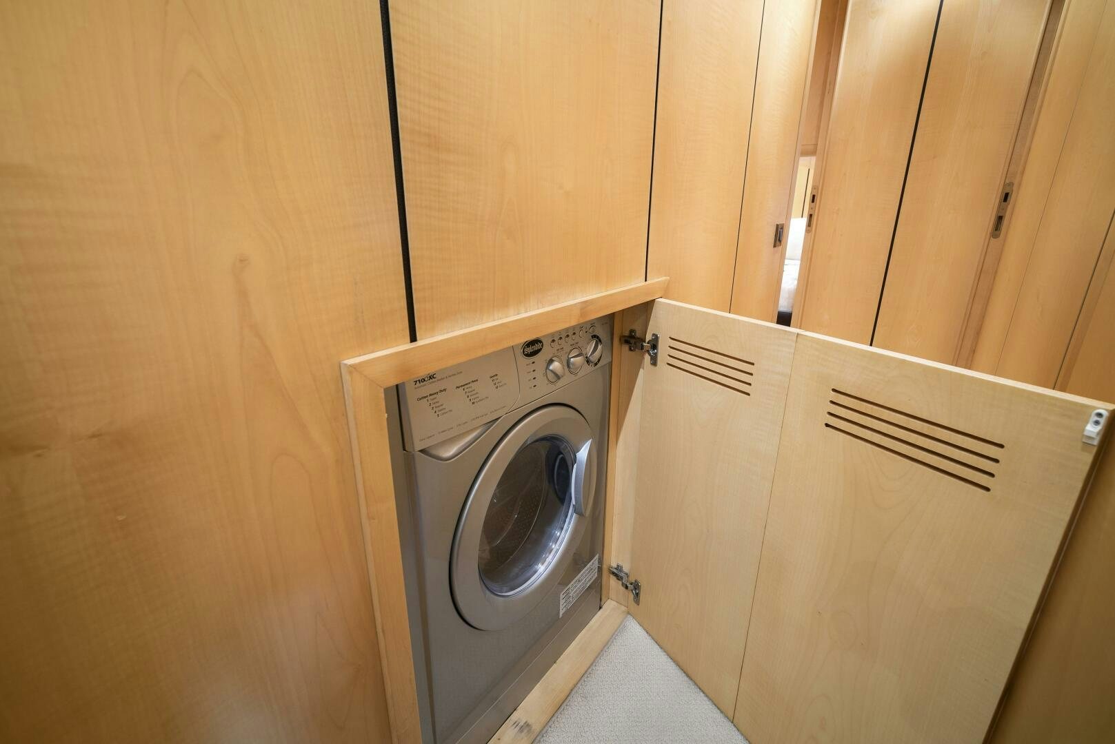 a washing machine in a wooden cabinet aboard NONE Yacht for Sale