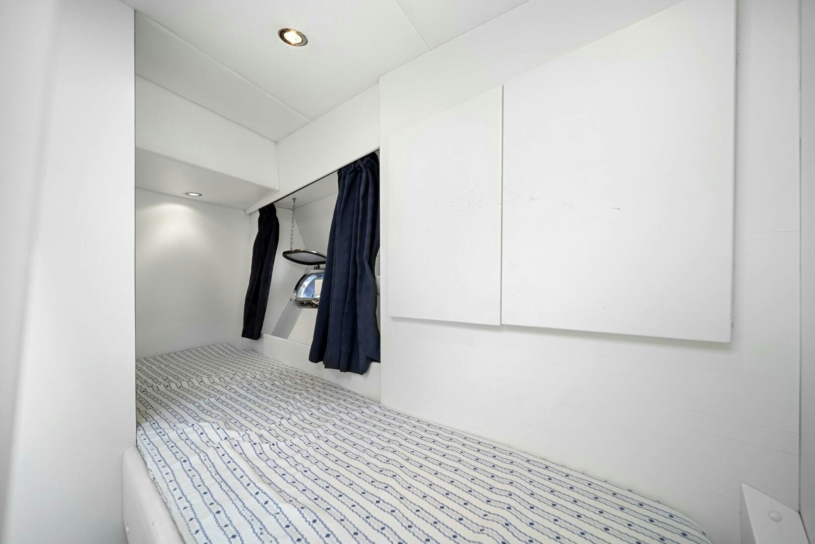 a white room with a black curtain aboard NONE Yacht for Sale