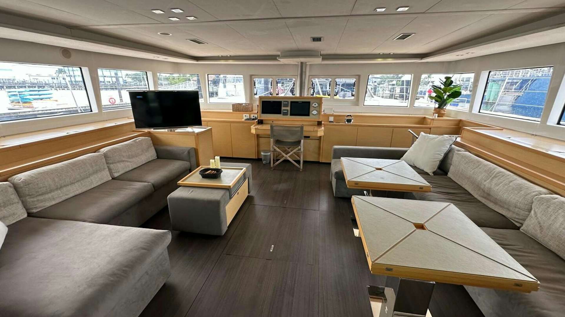 a room with couches and a tv aboard ZEN Yacht for Sale