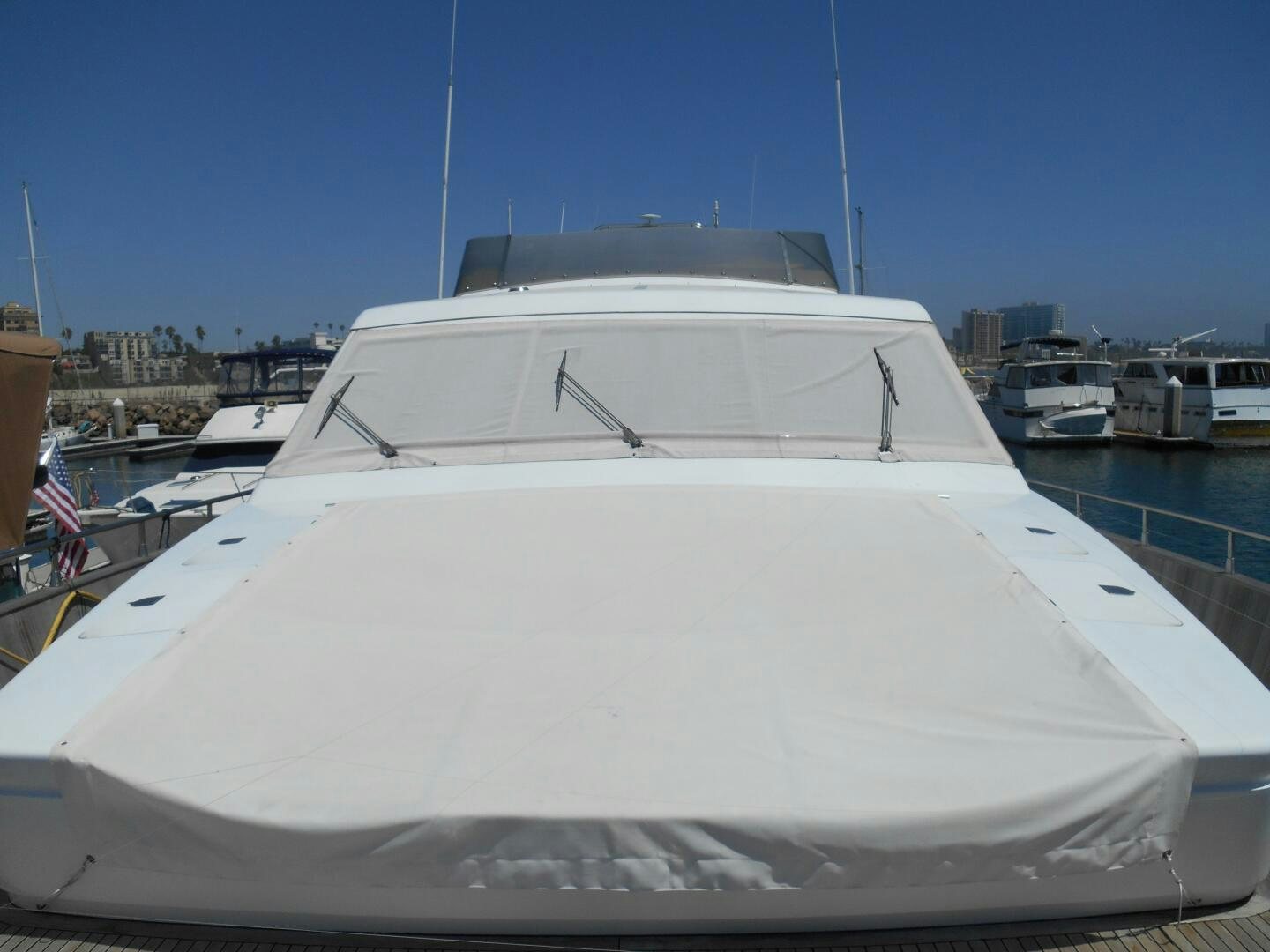 a white yacht in a harbor aboard LADY C Yacht for Sale