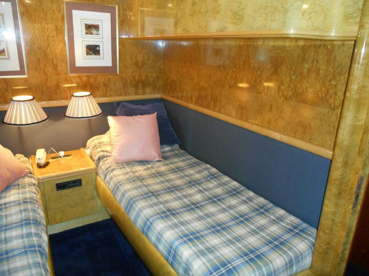 a person is sitting in a bed aboard LADY C Yacht for Sale