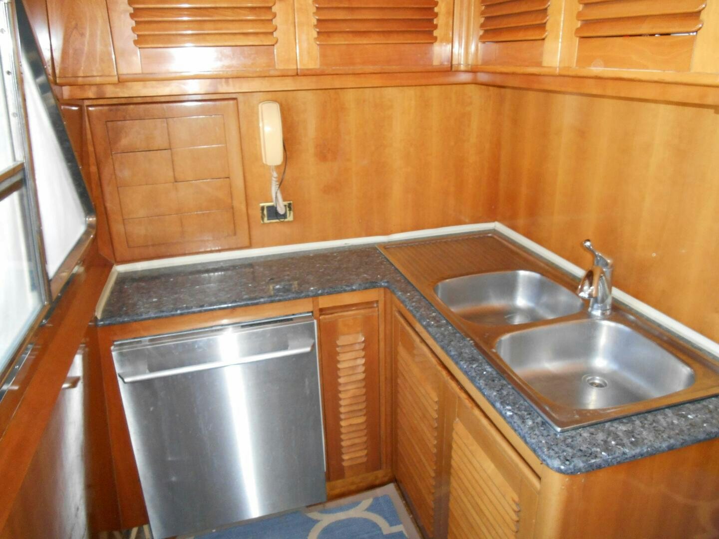 a kitchen with wooden cabinets aboard LADY C Yacht for Sale
